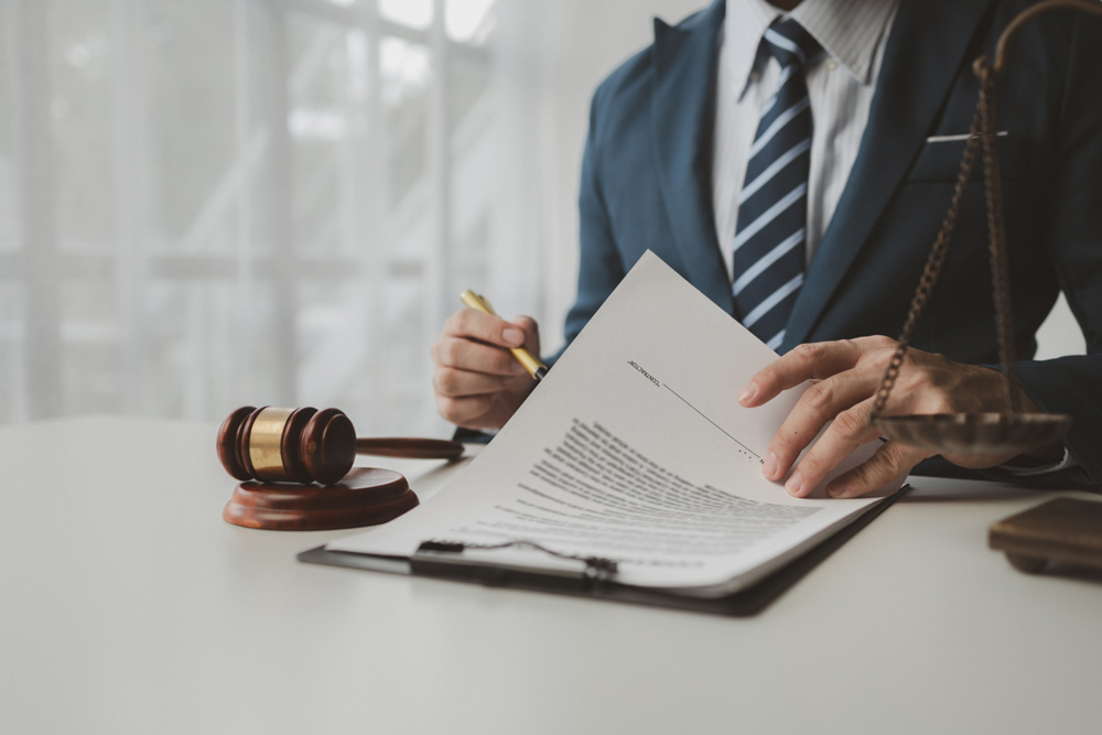 Lawyer is signing contract in the office, Diligent lawyer at work in a law firm, signing official document, Judge gavel with Justice lawyers, lawyer working on a documents, advice and justice concept