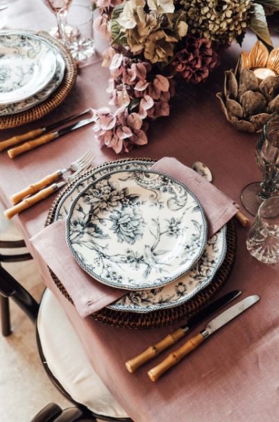 table-setting-with-plates-and-cutlery-near-flower