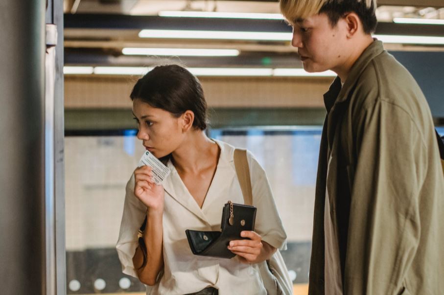people buying train tickets