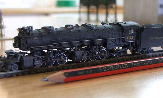 A pencil is used to demonstrate the scale of the Bachmann 2-6-6-2 N scale steam locomotive train model.